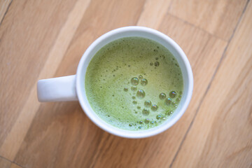 Matcha tea over wood background