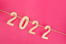 Wooden Number 2022 And Rope On Pink Background With Copy Space For Your Text Or Message.