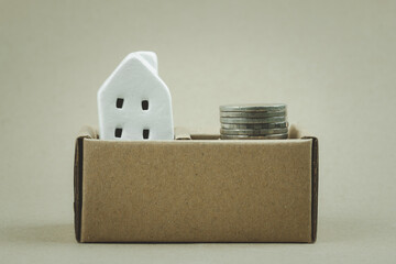 Poster - Miniature white home and coin money in brown paper box