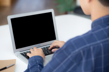 Wall Mural - young business man using laptop computer blank screen on desk at home, businessman work on notebook 