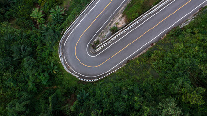 Wall Mural - Aerial view asphalt road in mountain pass with green forest, Countryside road passing through the green forrest and mountain.