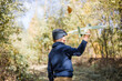 © Maria - Young boy play with toy airplaine in hands. Happy Kid is playing in park outdoors