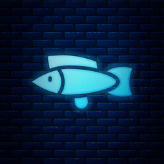 Sticker - Glowing neon Fish icon isolated on brick wall background. Vector