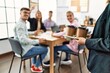 © Krakenimages.com - Group of business workers smiling happy working at the office. Partner man holding tray with take away coffee.