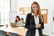 © Krakenimages.com - Mother and daughter business workers smiling confident standing with arms crossed gesture at office
