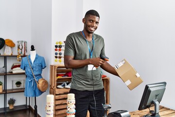 Wall Mural - Young african american man smiling confident working at clothing store