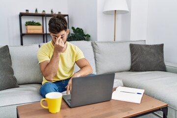 Sticker - Young man with beard using laptop at home tired rubbing nose and eyes feeling fatigue and headache. stress and frustration concept.