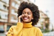 © Krakenimages.com - Young african american girl smiling happy talking on the smartphone at the city.