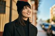 © Krakenimages.com - Young hispanic woman smiling happy standing at the city.