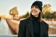 © Krakenimages.com - Young hispanic woman smiling happy standing at the city.