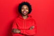 © Krakenimages.com - Young african american woman wearing casual sweatshirt happy face smiling with crossed arms looking at the camera. positive person.