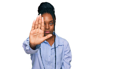 Wall Mural - Young african american woman wearing casual clothes doing stop sing with palm of the hand. warning expression with negative and serious gesture on the face.