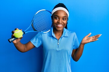 Sticker - African american woman with braided hair playing tennis holding racket and ball celebrating achievement with happy smile and winner expression with raised hand