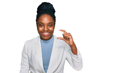 Sticker - Young african american woman wearing business clothes smiling and confident gesturing with hand doing small size sign with fingers looking and the camera. measure concept.