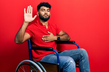 Poster - Arab man with beard sitting on wheelchair swearing with hand on chest and open palm, making a loyalty promise oath