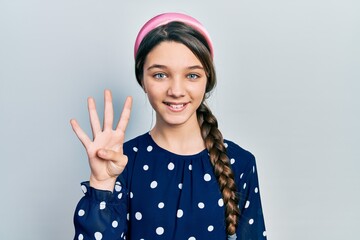 Wall Mural - Young brunette girl wearing elegant look showing and pointing up with fingers number four while smiling confident and happy.