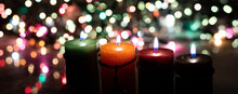Close Up Flame Candles With Decorative Lights On A Bokeh Black Background