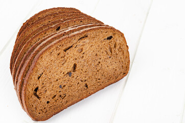 Wall Mural - Fresh homemade pastries. Sliced rye bread on wooden background. Studio Photo