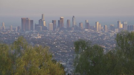 Wall Mural - Beautiful scenic view of Los Angeles before sunset. Highrise skyscrapers of metropolis in smog. Air toxic pollution and misty urban downtown skyline. Cityscape in dirty fog. Low visibility in city