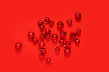 Red decorative balls in a white square pedestal on a red background.