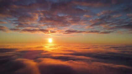 Poster - Aerial footage of setting sun up in the sky. Dramatic landscape over the clouds with sun just touching the horizon