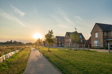 Canvas Print - Empty walkway path at sunset near new build housing area in southern England