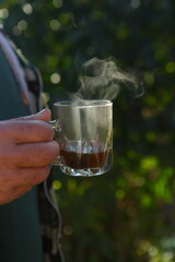 Wall Mural - Male hand holding a mug with tea