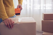 © Thanumporn - Close-up of packing a box.