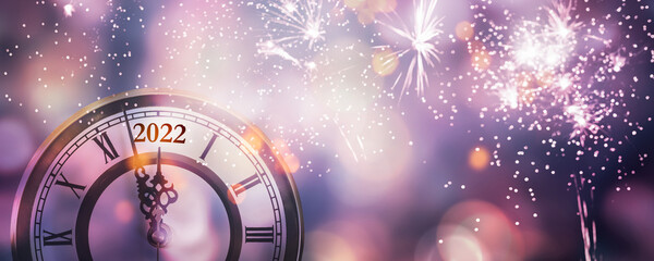 Wall Mural - countdown clock 2022 at new years celebration night with firework explosion, abstract party concept for happy new year party with blurred lights on colorful background