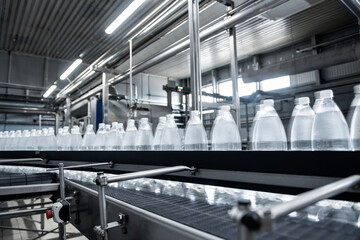 Wall Mural - Conveyor belt with bottles of drinking water at a modern beverage plant.