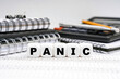 © Dzmitry - On the table, among office objects, cubes with the inscription - PANIC