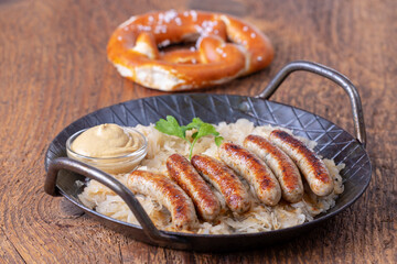 Wall Mural - grilled nuremberger bratwurst with sauerkraut