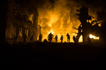 Wall Mural - War Concept. Military silhouettes fighting scene on war fog sky background, World War Soldiers Silhouette Below Cloudy Skyline At night. Battle in ruined city. Selective focus