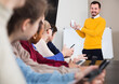 © JackF - male and female students following explanations of friendly teacher in class