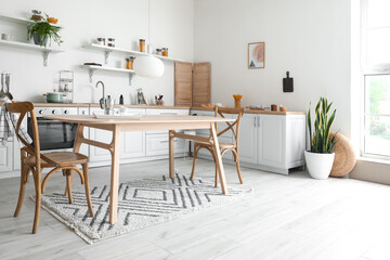 Stylish kitchen interior with wooden dining table