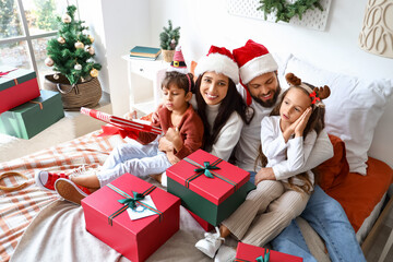 Poster - Happy family with Christmas gifts in bedroom