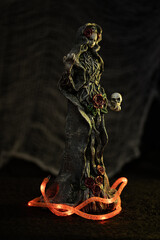 Poster - Vertical shot of a Halloween figurine against a blurry dark background