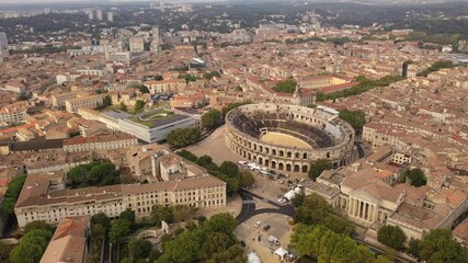 Wall Mural - Aerial view of historical area of French city of Nimes overlooking restored antique Roman amphitheatre on sunny autumn day . High quality 4k footage