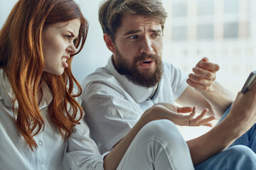 Wall Mural - Man and woman sit near the window with headphones together apartments technology