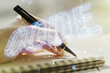 © Pixels Hunter - Creative Code word hologram and woman hand writing in notepad on background, artificial intelligence and neural networks concept. Multiexposure