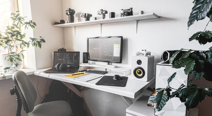 Empty modern developer workplace for writing code with computer desktop and comfy armchair