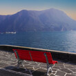 iconic red bench on the lakefront in Lugano, Switzerland