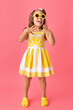 © Lisa Tichané - Funny little girl on pink background wearing lemon dress