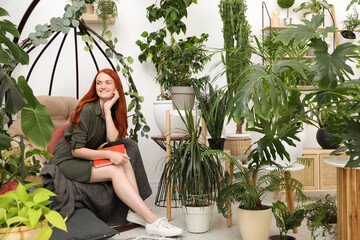 Sticker - Happy beautiful woman with book in egg chair at home