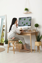 young woman working at table in light room. home office