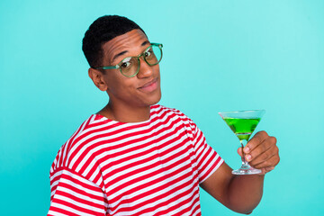 Sticker - Photo of funky charming young man wear striped t-shirt smiling drinking cocktail isolated teal color background