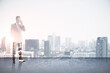 © Who is Danny - Attractive young european man talking on the phone on abstract rooftop white city background with mock up place. Success and leadership concept. Double exposure.