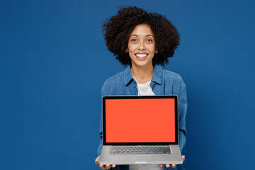 Young black woman in casual clothes shirt white t-shirt hold use work on laptop pc computer with blank screen workspace area isolated on plain dark blue background studio. People lifestyle concept