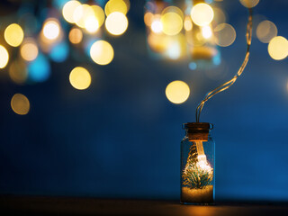 Wall Mural - Christmas garland, Christmas tree in a glass jar on a blue background, copy space