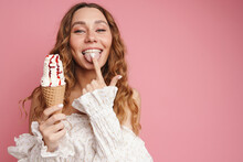 Young Ginger Woman In Dress Smiling While Eating Ice Cream